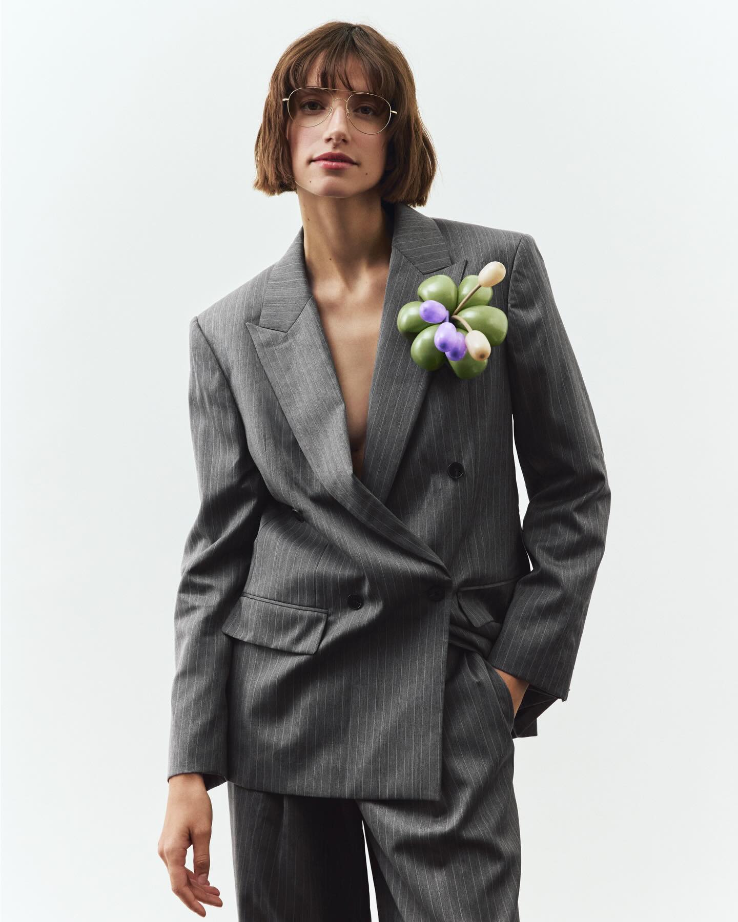 Woman in suit and aviator eyeglasses